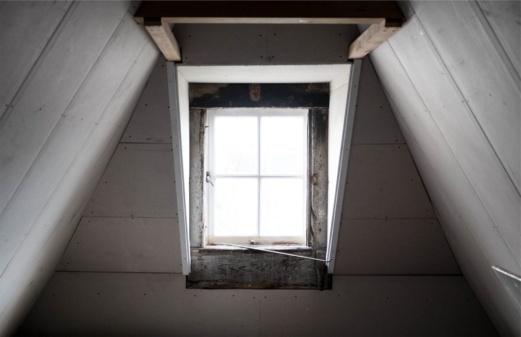 Inspecting the attic space with window 