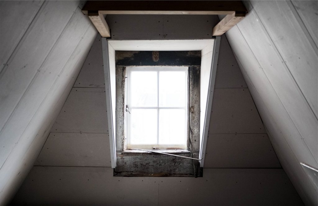Inspecting the attic space with window